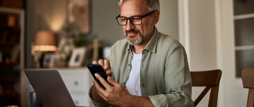 a man using a smartphone in a living room