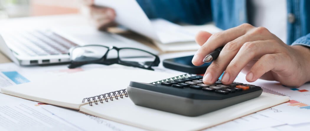 close-up of a hand using a calculator