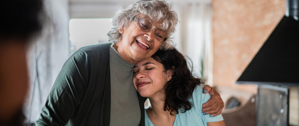 young woman hugging older family member